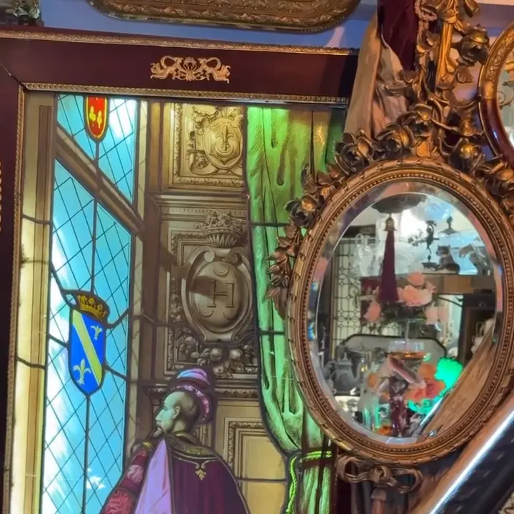 Stained glass and an ornate mirror reflecting objects inside the Jaffa maison